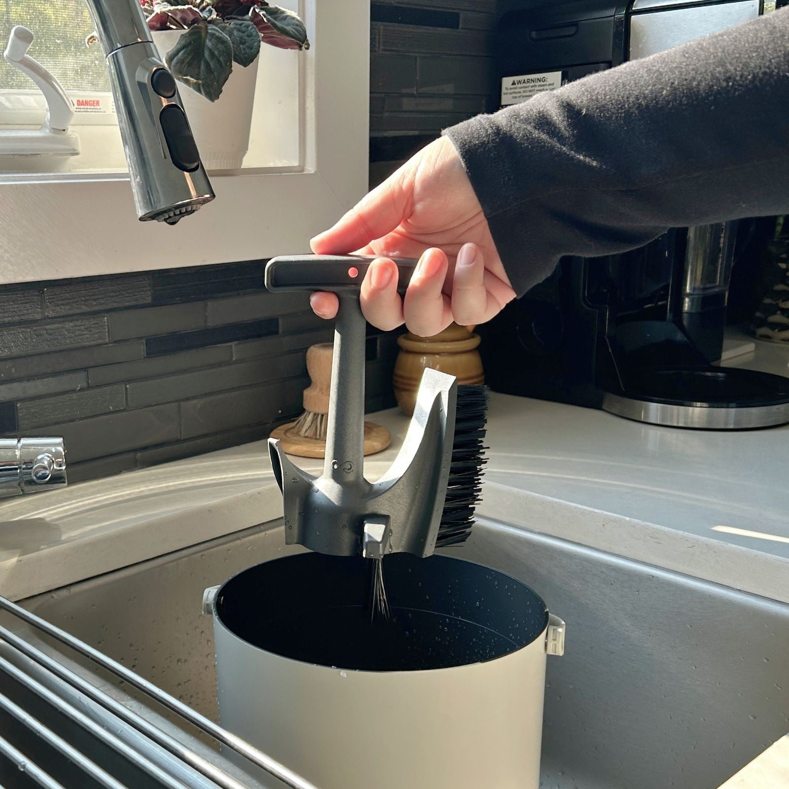 Person placing the Infinity Brush inside their Eco 3 Bucket
